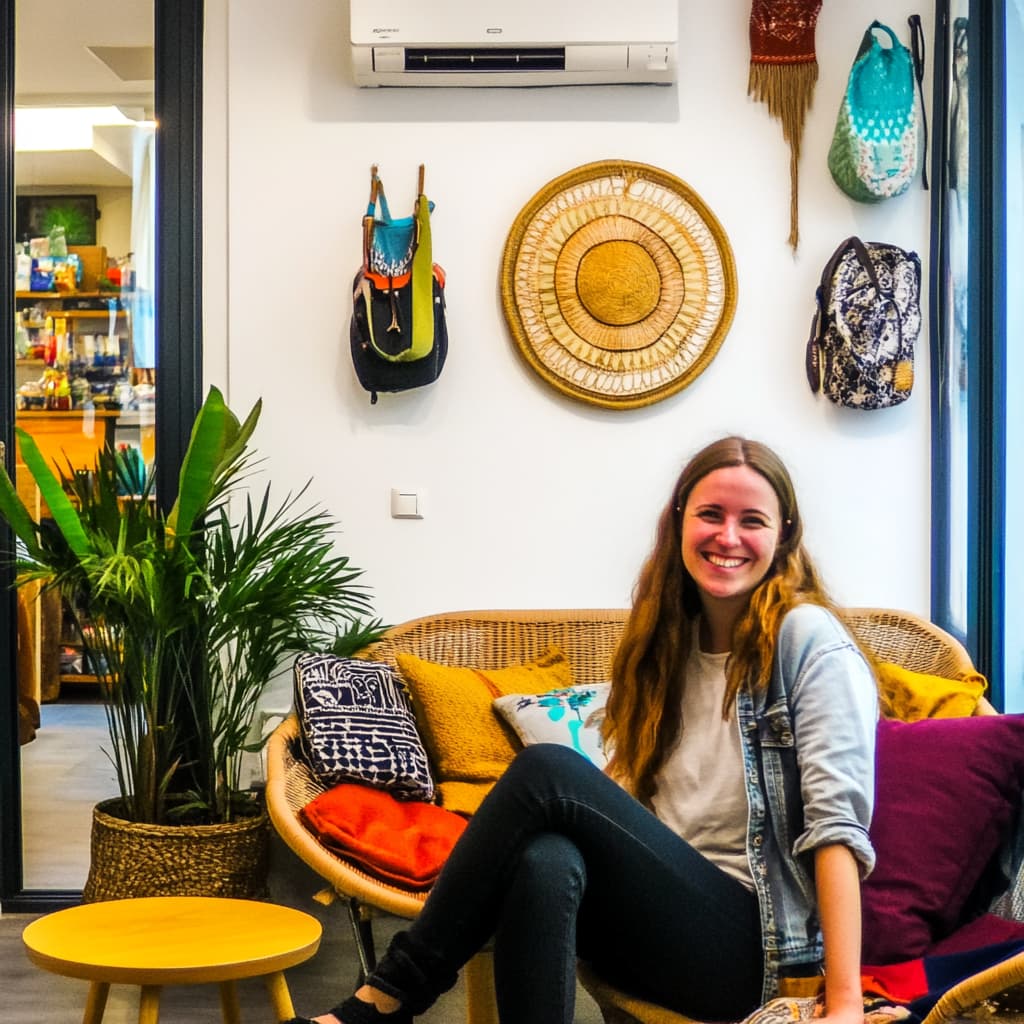 A cheerful traveler lounging in a charming, budget-friendly hostel with cozy décor, interacting with fellow travelers from around the world. ai generated